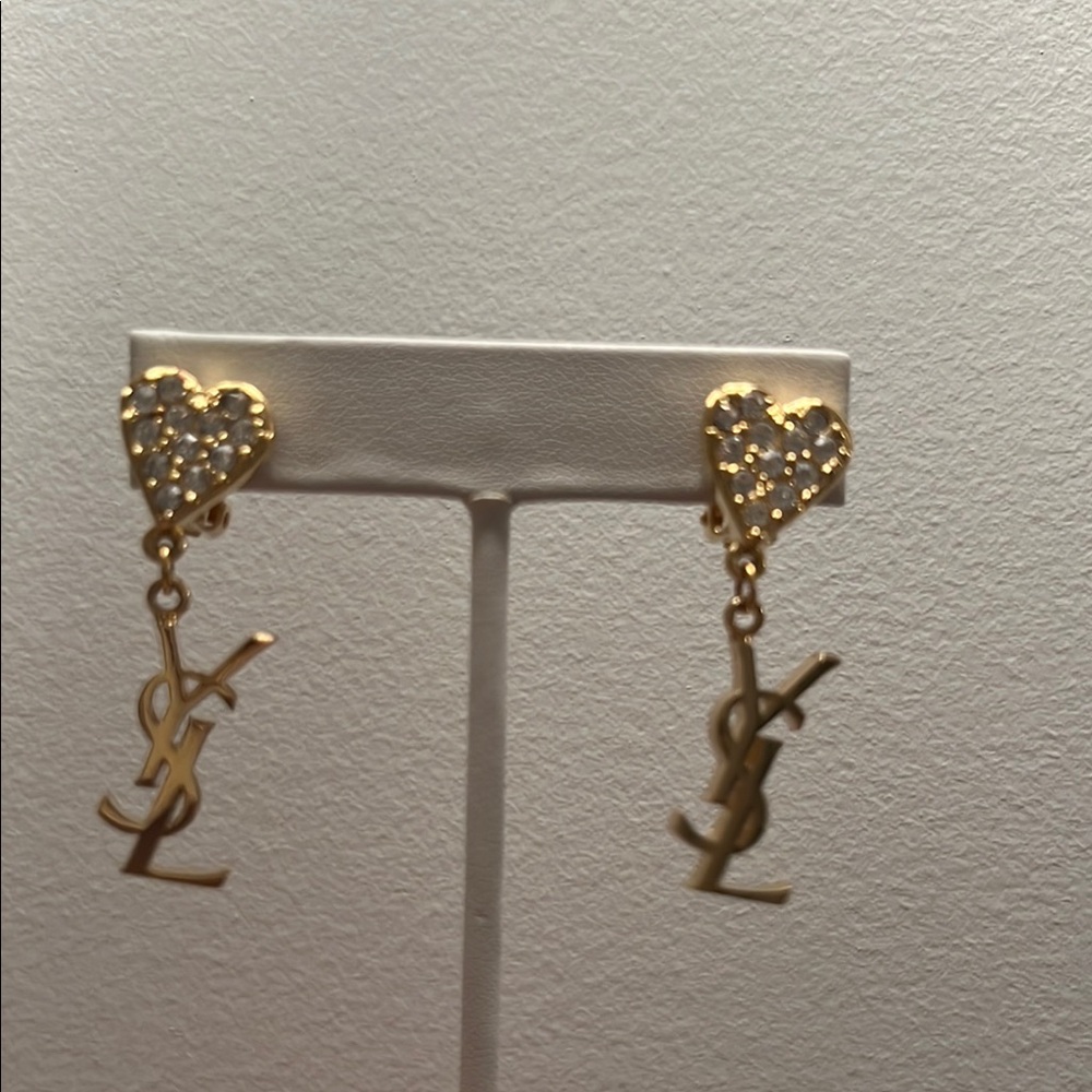 YSL Gold Heart Earrings The heart is full of rhinestones and then you have YSL.